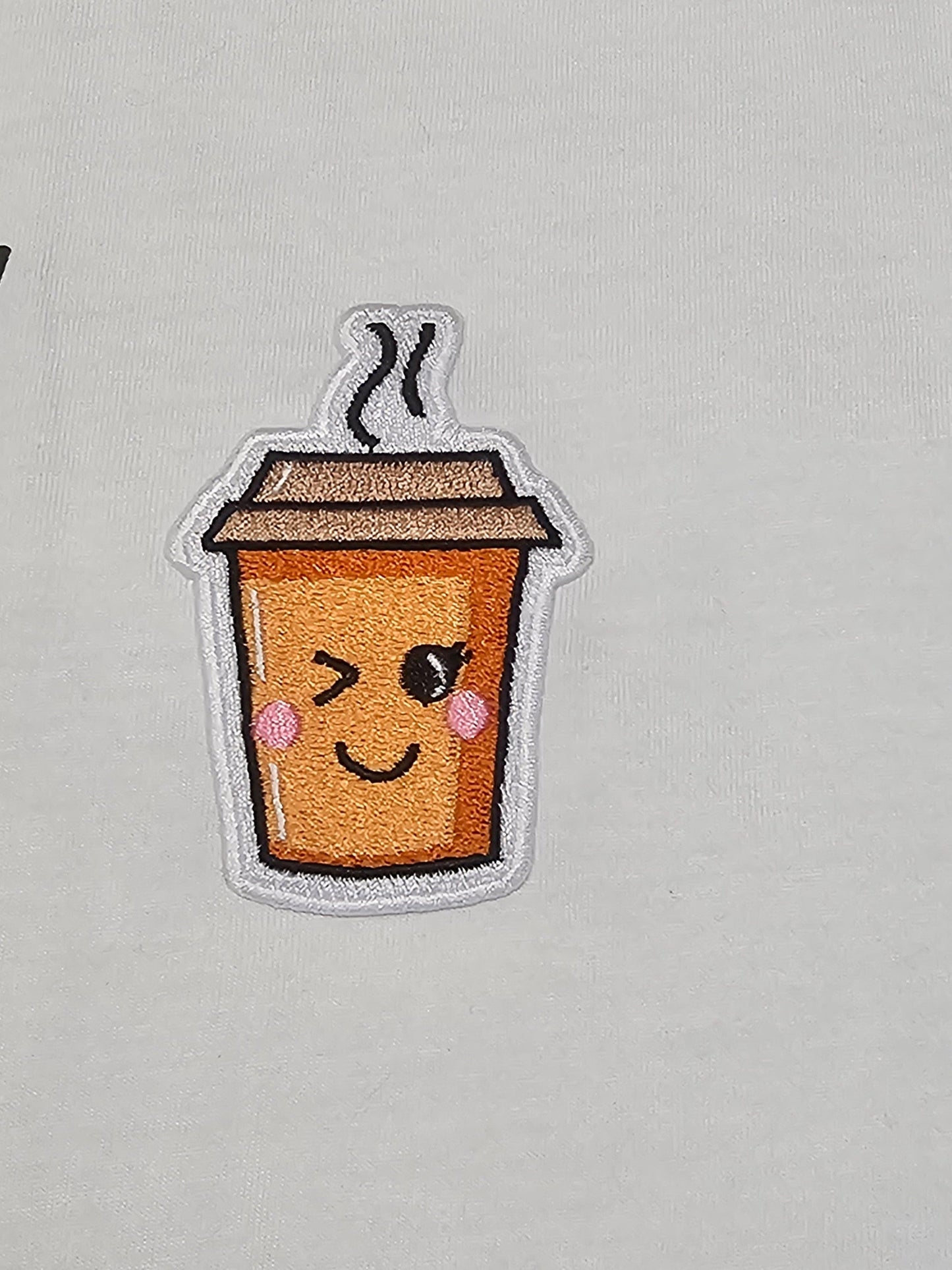 'Mi corazon Latte por ti" Short-sleeve, soft syle t-shirt with a cute embroidered coffee cup patch.